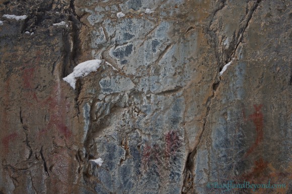 human-animal-ancient-pictograph-red-ochre-drawing-limestone-cliff-face-grotto-canyon-canmore-alberta