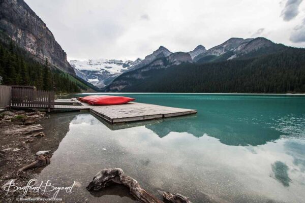 red canoes and docks at lake louise boathouse
