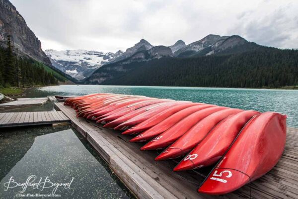 red canoes lined up at dock at lake louise boathouse