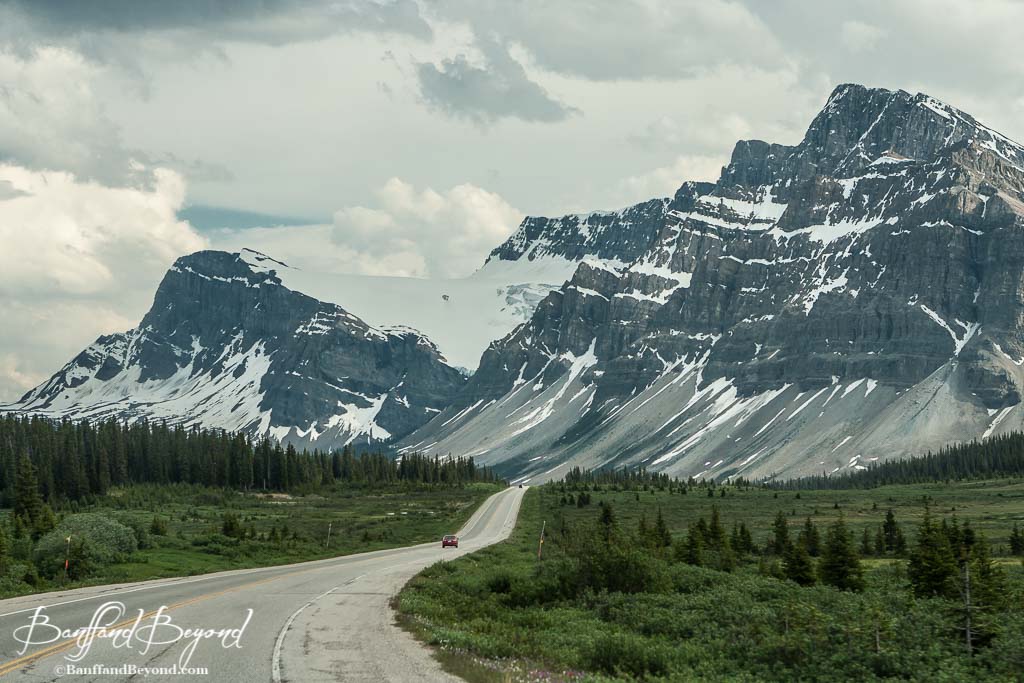 the icefields parkway heading towards an ice capped mountain range