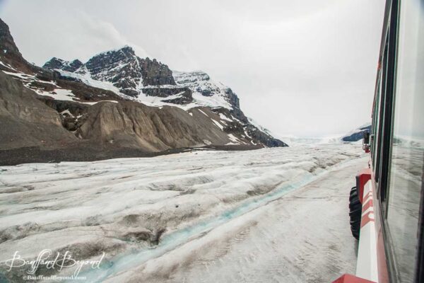 ice explorer traveling along athabasca glacier at the columbia icefields