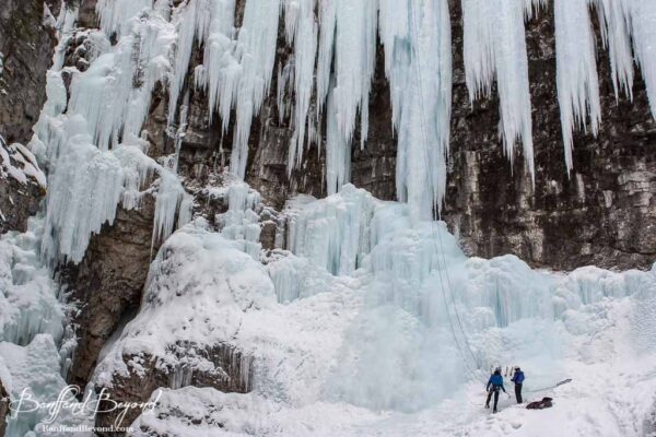 ice climbers at frozen johnston canyon falls in banff national park