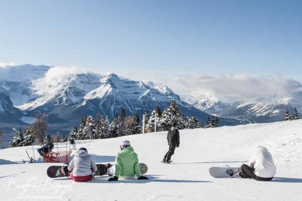 snowboarders on the top of lake louise ski hill