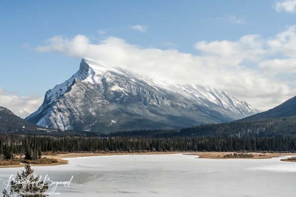 mount rundle and vermilion lakes slightly frozen in spring