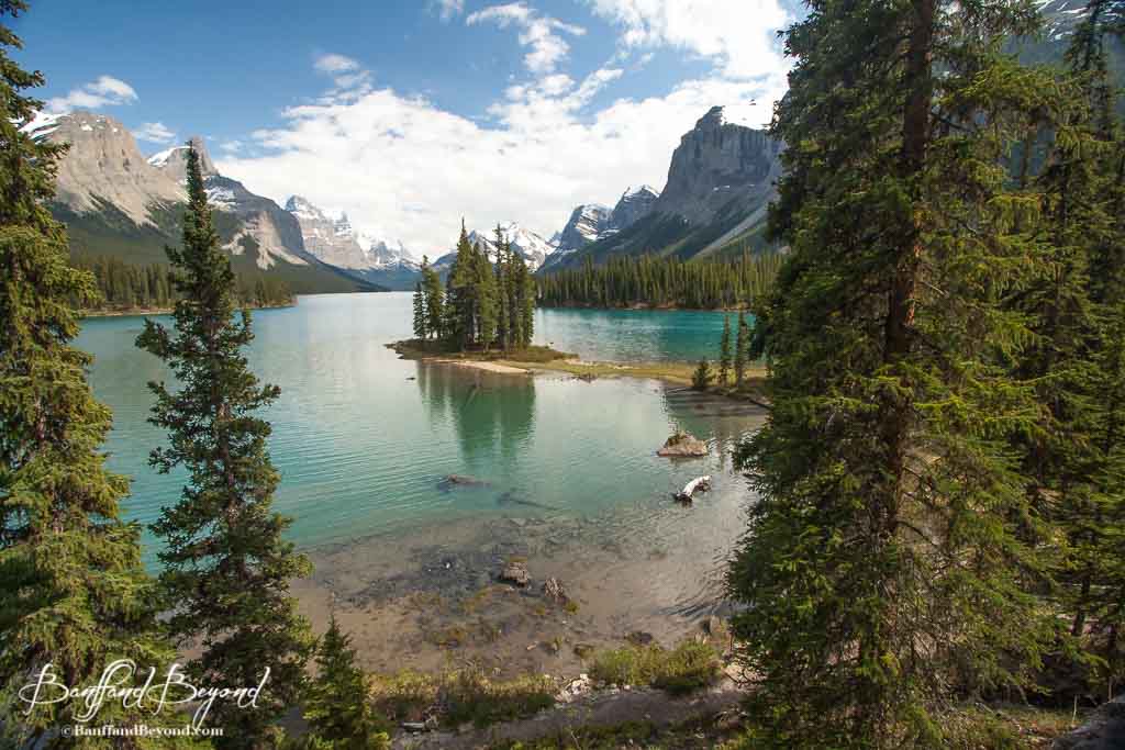 spirit island and maligne lake with mountains and evergreen forest
